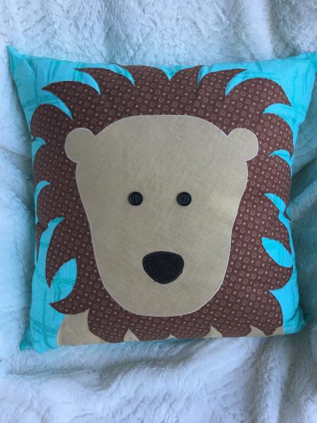 Lion appliqué on teal pillow