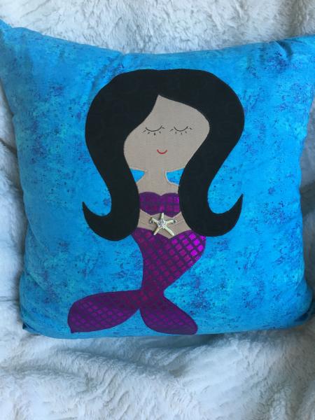Mermaid appliqué on turquoise pillow