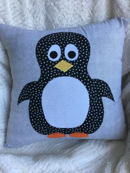 Penguin appliqué on black and white pillow