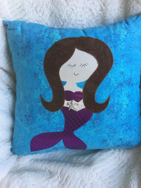 Mermaid appliqué on turquoise pillow