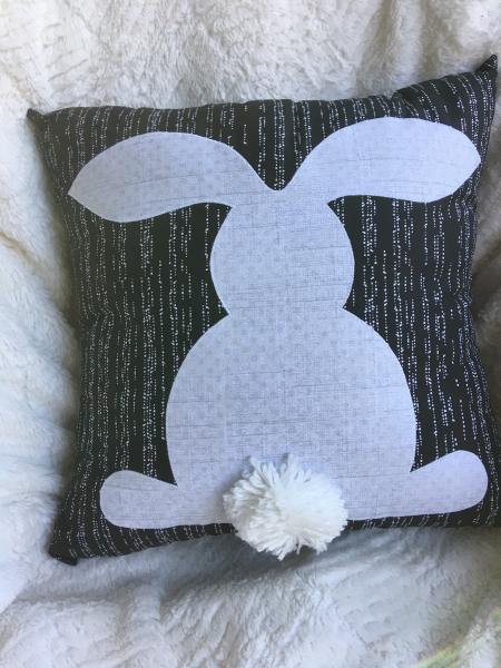 Rabbit on black and white pillow