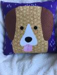 Brown and tan dog appliqué on purple and white background pillow