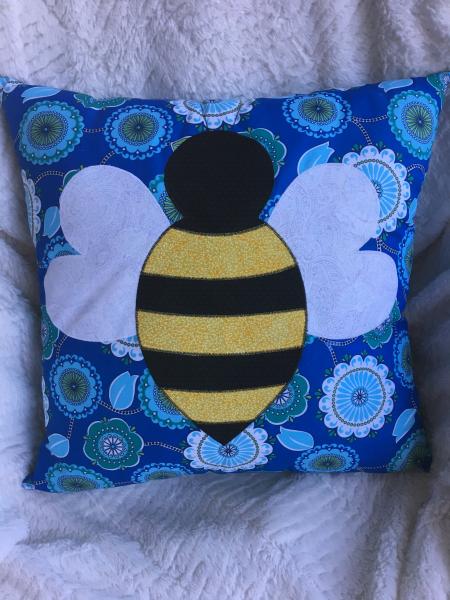Bumblebee appliqué on blue pillow