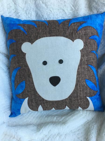 Lion appliqué on turquoise pillow