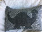 Dinosaur on grey pillow