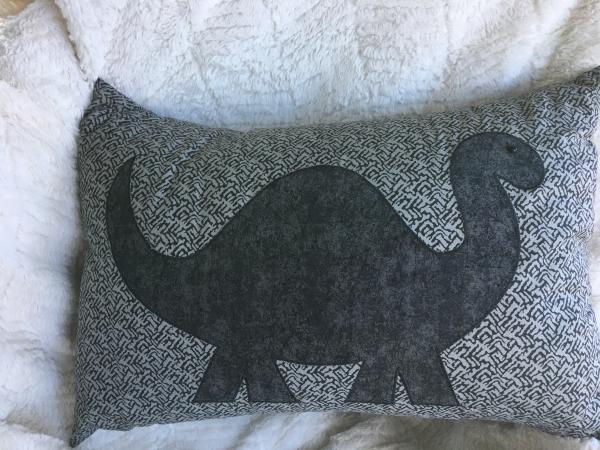 Dinosaur on grey pillow picture