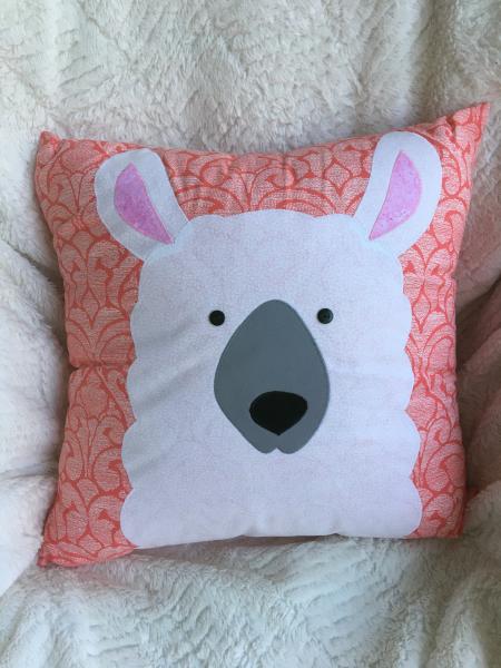 Llama appliqué on coral background pillow picture