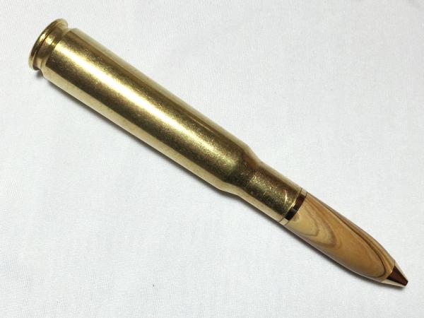 50 caliber machine gun bullet pen made with various woods, gold hardware, and a genuine casing