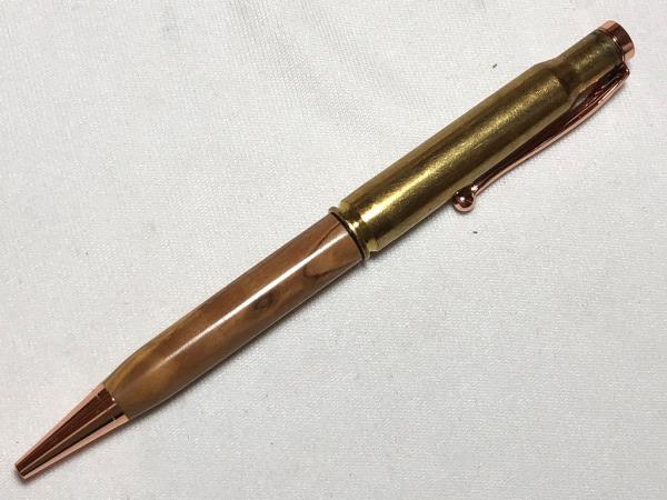 30.06 caliber bullet pen made with various woods, copper hardware, and a genuine casing