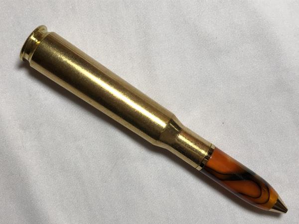 50 caliber machine gun bullet pen made with various acrylics, gold hardware, and a genuine casing