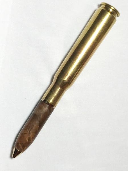 50 caliber machine gun bullet pen made with various woods, gold hardware, and a genuine casing