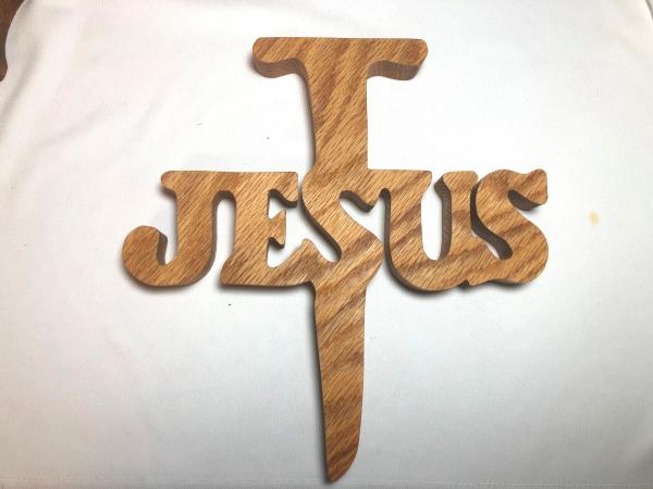Jesus and nail scroll sawed from solid oak, walnut or other wood.