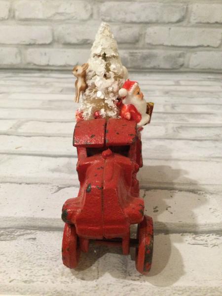 Antique red iron truck filled with vintage and antique decorations picture
