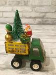 Antique Tonka green and yellow truck filled with antique Christmas ornaments and vintage decorations