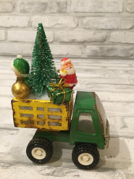 Antique Tonka green and yellow truck filled with antique Christmas ornaments and vintage decorations