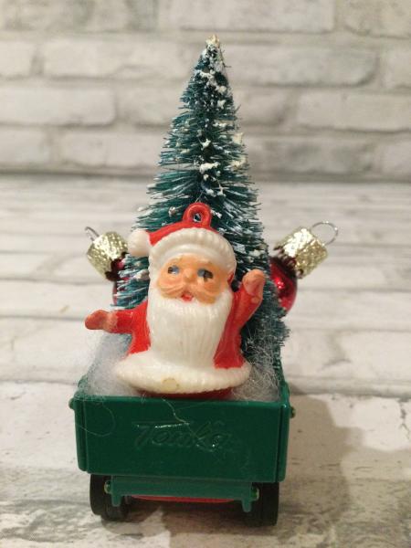 Vintage red and green dump truck  filled with vintage Christmas decorations picture