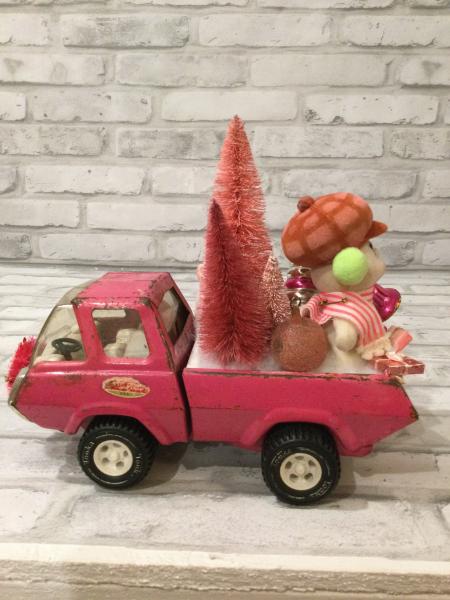 Vintage pink Tonga truck filled with antique Christmas decorations picture