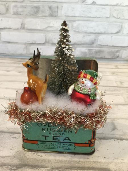 Antique tin filled with vintage Christmas decorations