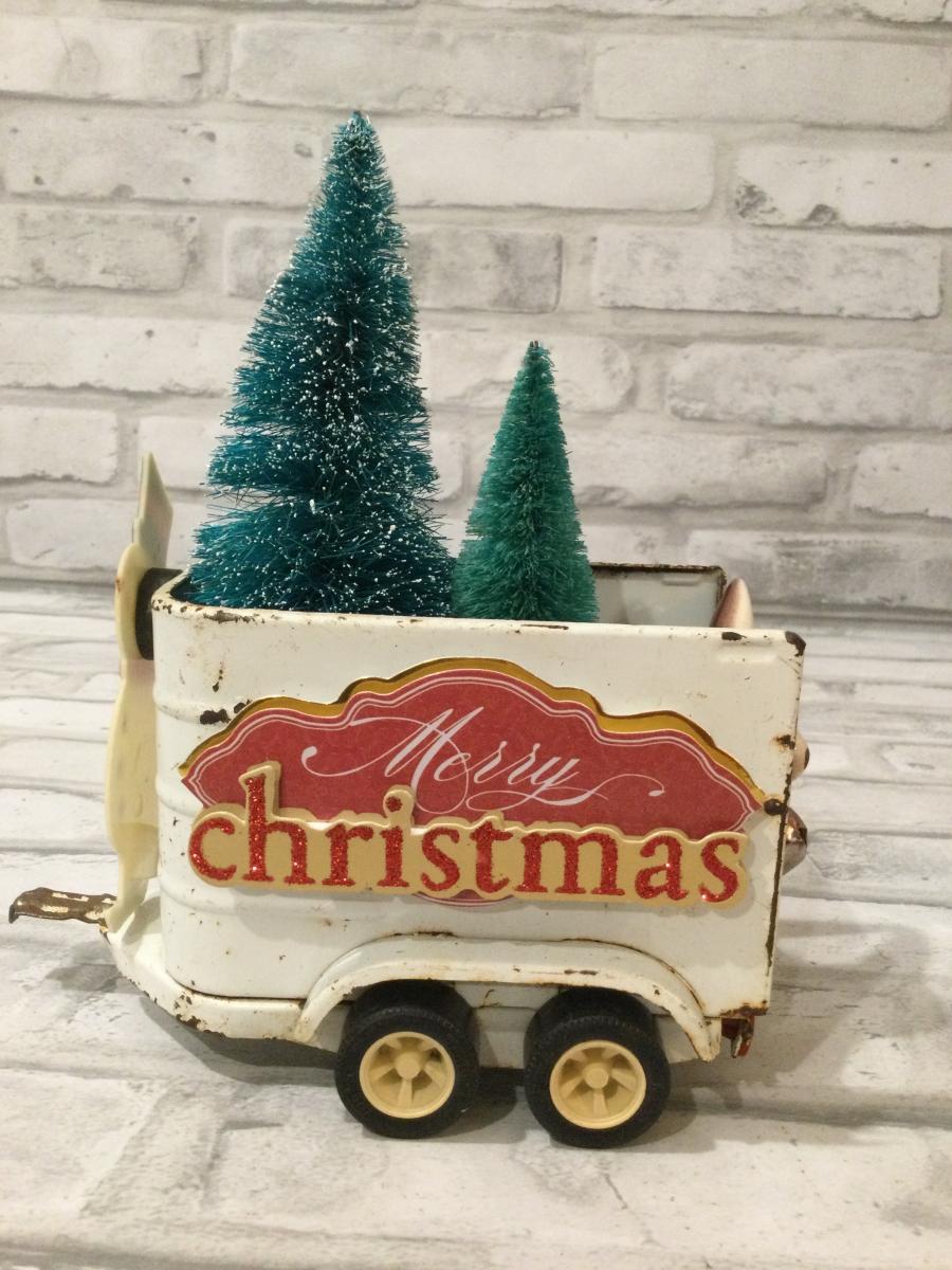 Vintage white horse trailer filled with antique decoration and bottle brushed trees picture