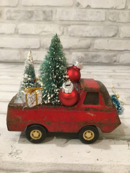 Antique Tonka truck filled with antique bottle brush tree. picture