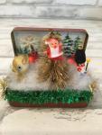 Vintage tin filled with antique Christmas card back drop and antique decorations