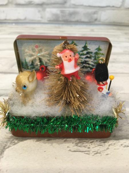 Vintage tin filled with antique Christmas card back drop and antique decorations