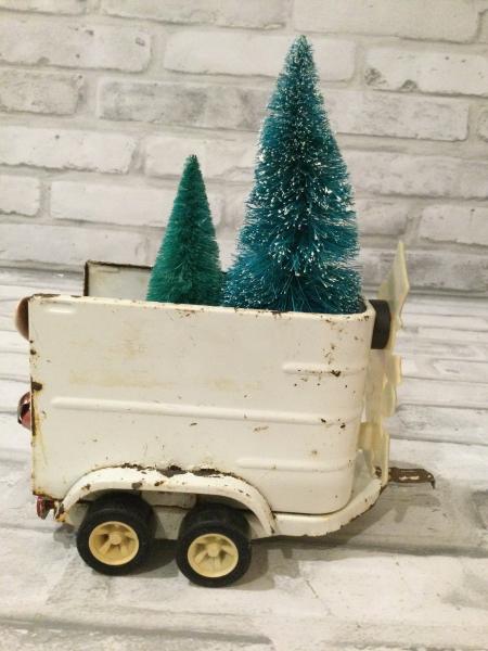Vintage white horse trailer filled with antique decoration and bottle brushed trees picture