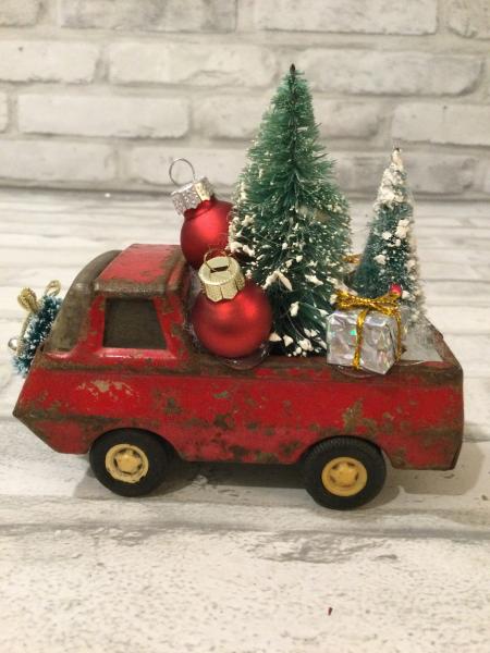 Antique Tonka truck filled with antique bottle brush tree.