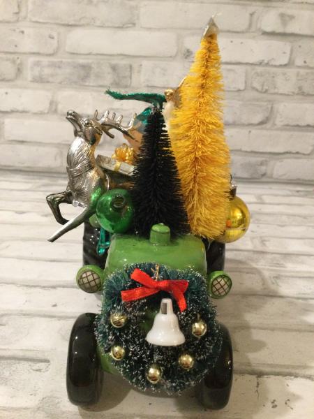 Green tractor with antique decorations and ornaments picture