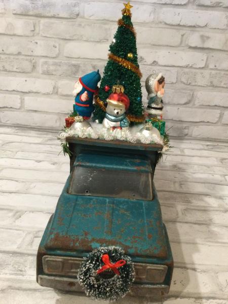 Antique teal dump truck filled with antique decorations picture