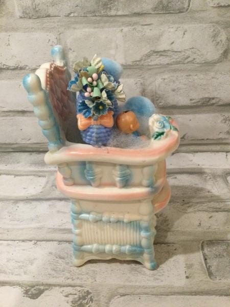 Antique baby high chair filled with antique and vintage decorations picture