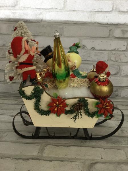 Sleigh filled with antique Christmas decorations. picture