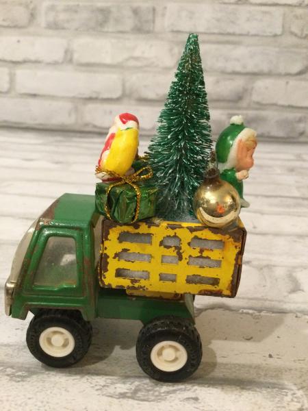 Antique Tonka green and yellow truck filled with antique Christmas ornaments and vintage decorations picture