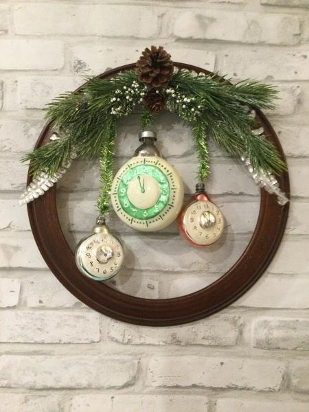 Wood circle wall hanging with Czechoslovakian clock ornaments.