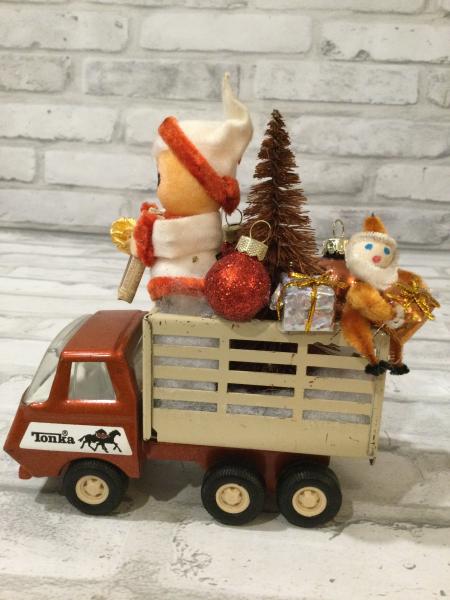 Vintage Tonka truck filled with antique Christmas decorations