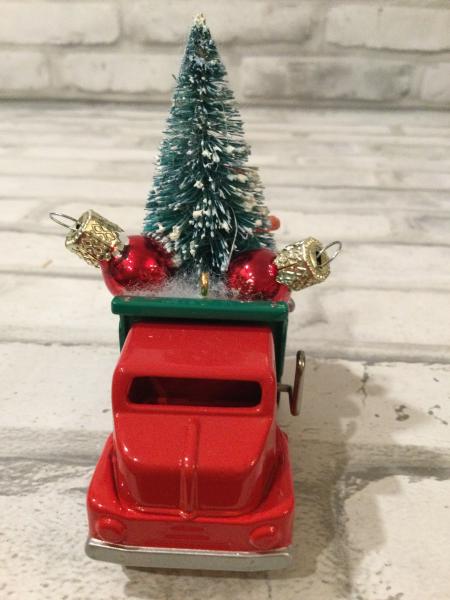 Vintage red and green dump truck  filled with vintage Christmas decorations picture