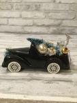 Vintage black truck filled with antique Christmas ornaments and vintage decorations