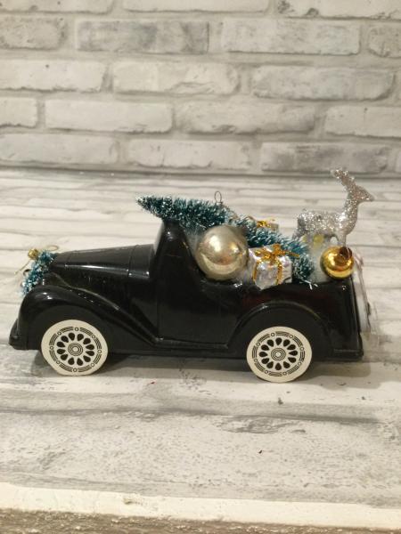 Vintage black truck filled with antique Christmas ornaments and vintage decorations picture