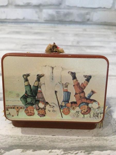 Vintage tin filled with antique Christmas card back drop and antique decorations picture
