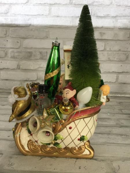 Vintage sleigh filled with antique Christmas and vintage decorations