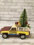 Vintage Ertl wrangler ranch pickup truck filled with antique Christmas decorations