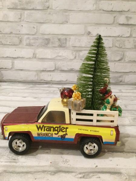 Vintage Ertl wrangler ranch pickup truck filled with antique Christmas decorations