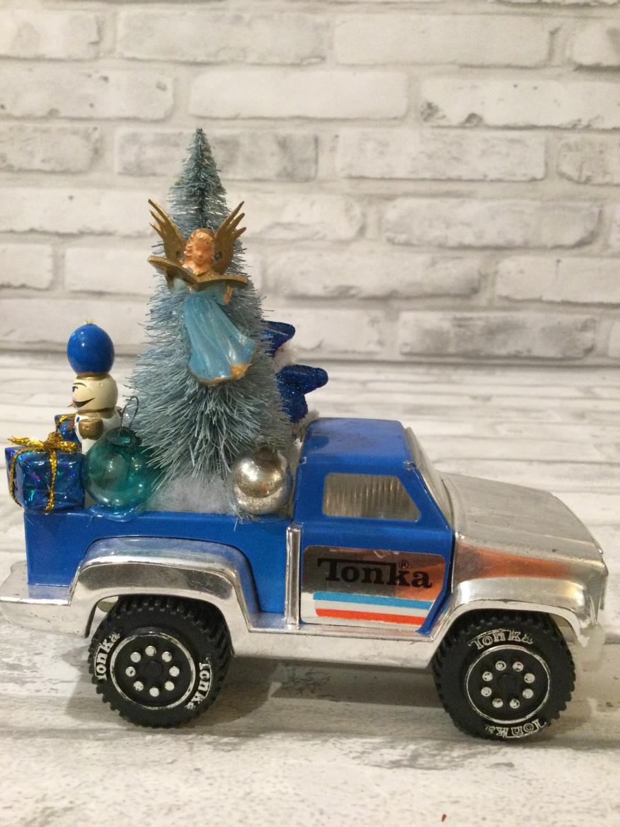 Vintage blue Tonka truck filled with antique Christmas decorations and ornaments. picture