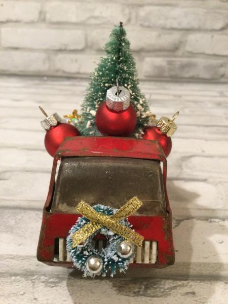 Antique Tonka truck filled with antique bottle brush tree. picture