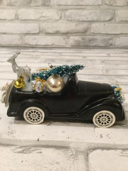 Vintage black truck filled with antique Christmas ornaments and vintage decorations picture
