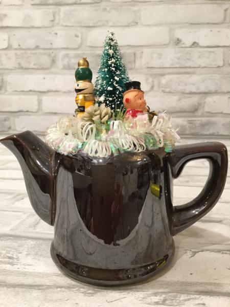 Brown tea pot with antique ornaments and vintage picture