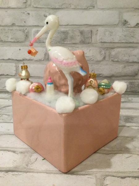 Antique baby girl planter filled with antique decorations picture