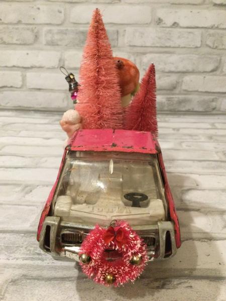 Vintage pink Tonga truck filled with antique Christmas decorations picture