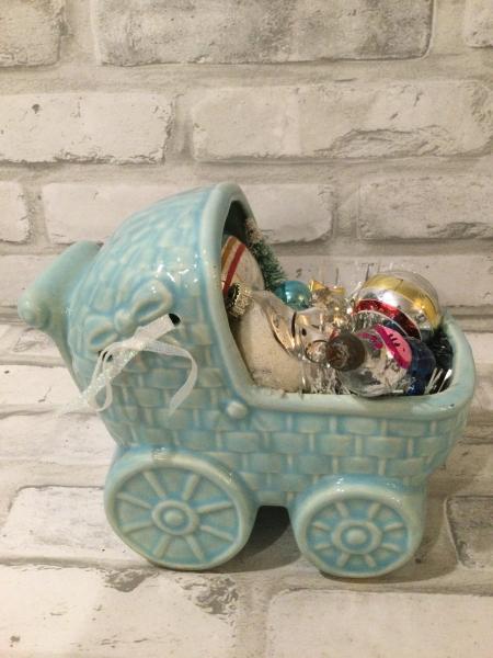 Antique baby carriage filled with antique decorations. picture