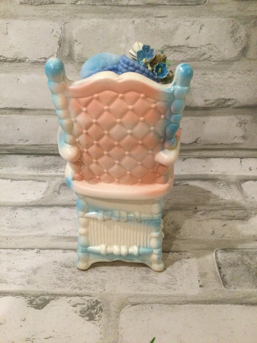Antique baby high chair filled with antique and vintage decorations picture